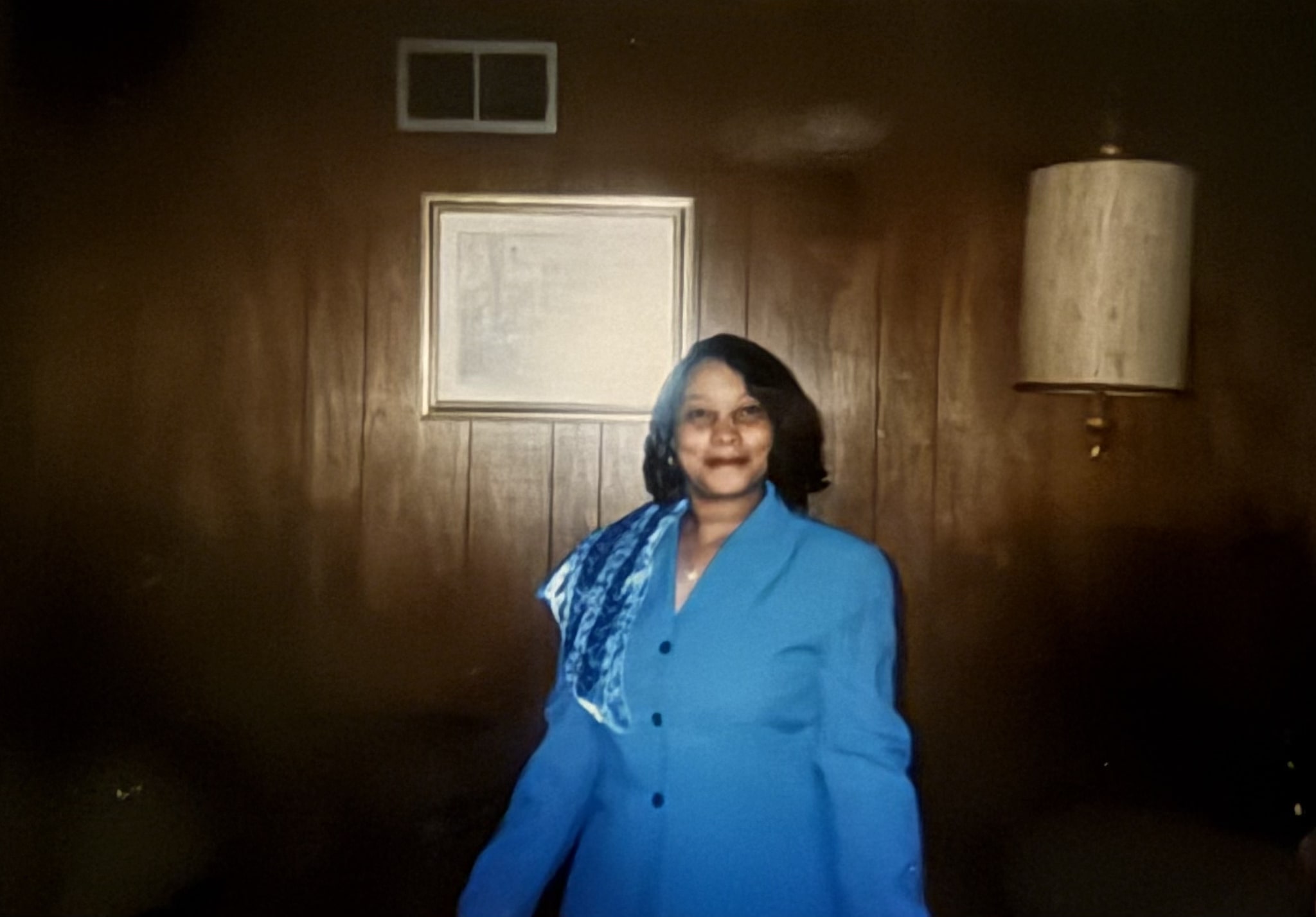 A younger Mrs. Poe wearing a royal-blue suit