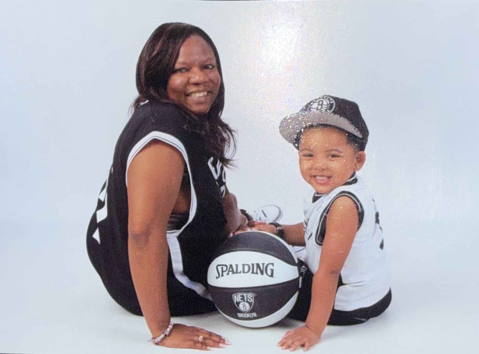 Mrs. Poe and a young family member in a basketball portrait